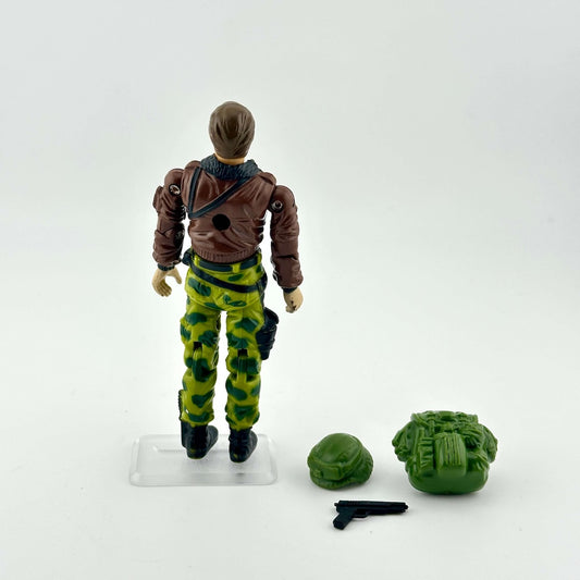 GI Joe action figure in camouflage military gear with accessories on white background. 