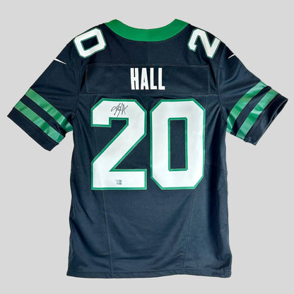 A black Jets football jersey with 'HALL' and the number '20' on the back, featuring a green collar, and a black autograph.