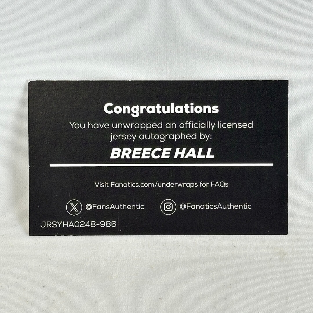 A black rectangular autograph wrap card with white text celebrating a jersey autograph from Breece Hall.
