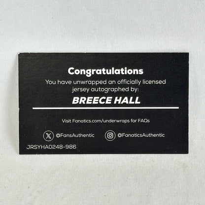 A black rectangular autograph wrap card with white text celebrating a jersey autograph from Breece Hall.
