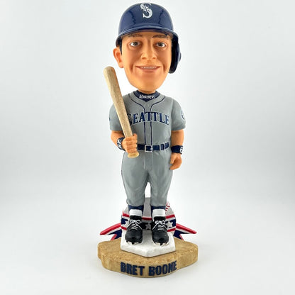 Bobblehead of a baseball player in Seattle Mariners uniform holding a bat on a white background