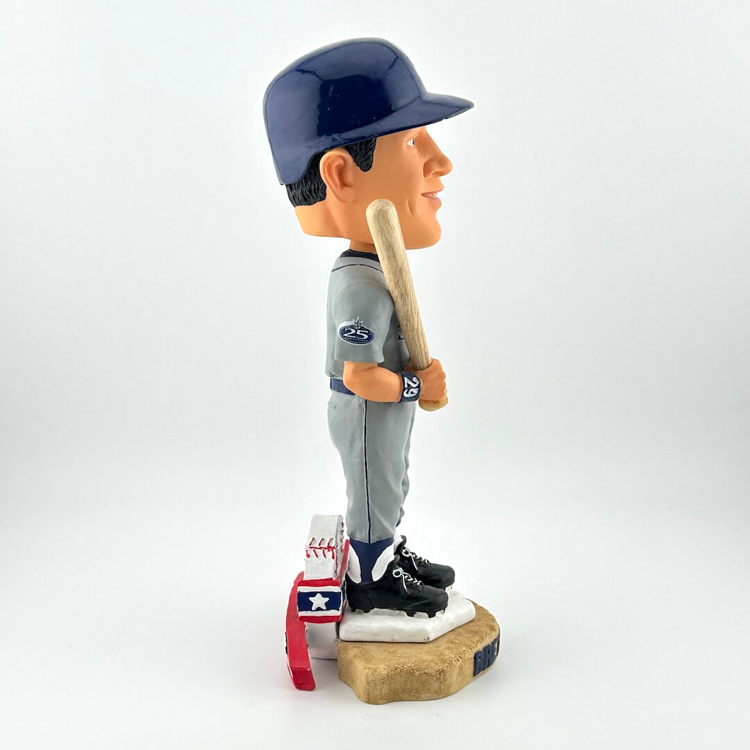 Bobblehead of a baseball player holding a bat on a white background