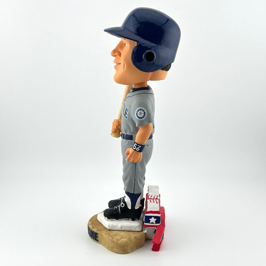 Bobblehead of a baseball player in a gray uniform with a helmet on a white background