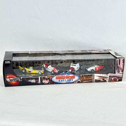 A Hot Wheels die-cast model car set in its original window box packaging, featuring several race cars.