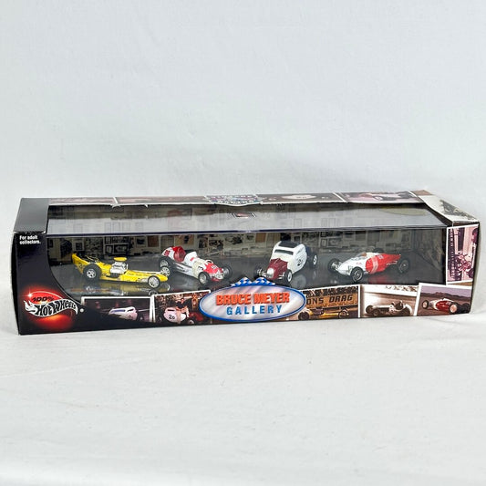 A Hot Wheels die-cast model car set in its original window box packaging, featuring several race cars.