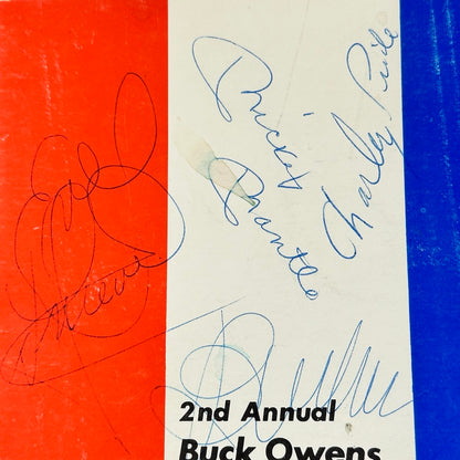 Close-up of blue pen ink signatures of Mickey Mantle, Charley Pride, Evel Knievel, & Buck Owens. 