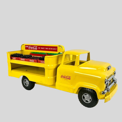 Yellow toy truck with Coca-Cola branding on a white background