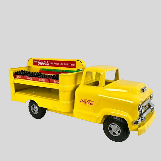 Yellow toy truck with Coca-Cola branding on a white background