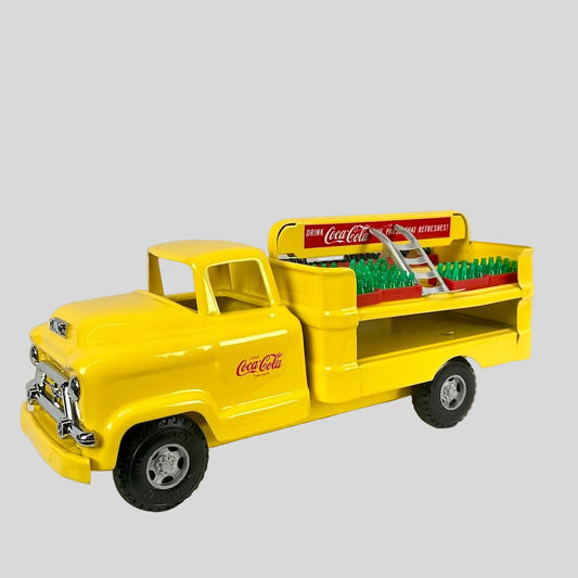 Yellow toy truck with Coca-Cola branding on a light gray background