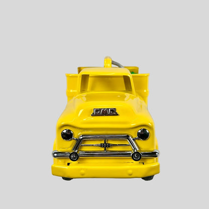 Yellow toy truck with 'GMC' branding on a light gray background