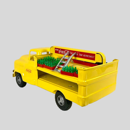 Yellow toy truck with Coca-Cola branding on a white background