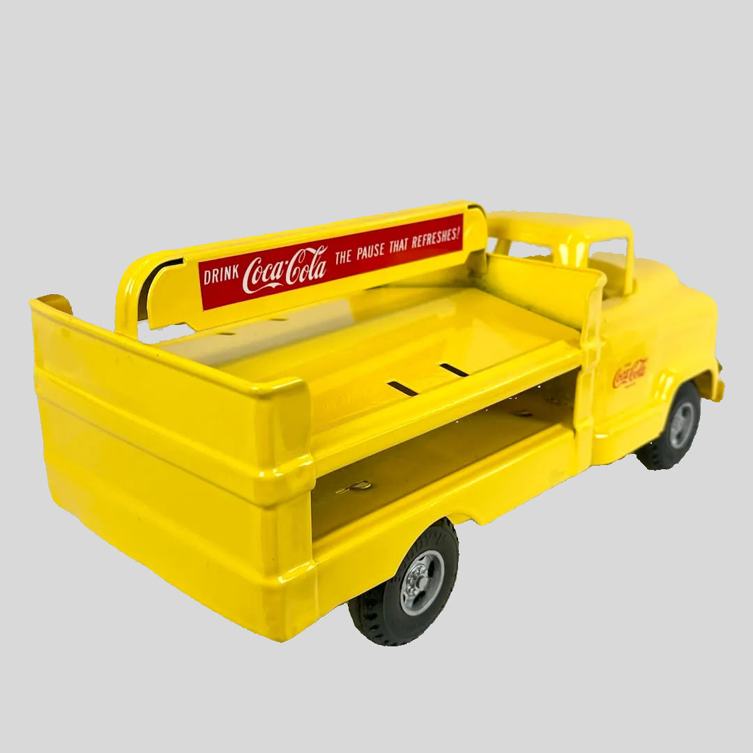 Yellow toy truck with Coca-Cola branding on a white background