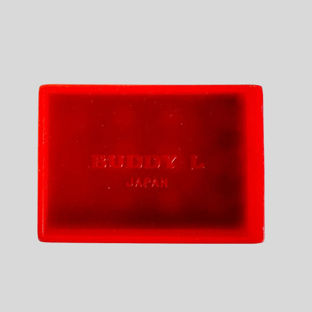 Red plastic rectangle with 'Buddy L Japan' branding on a light background