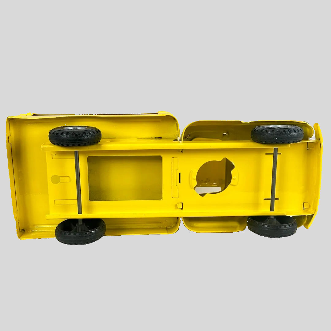 Yellow toy truck with black wheels on a white background