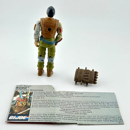 G.I. Joe action figure with accessories and card on a white background