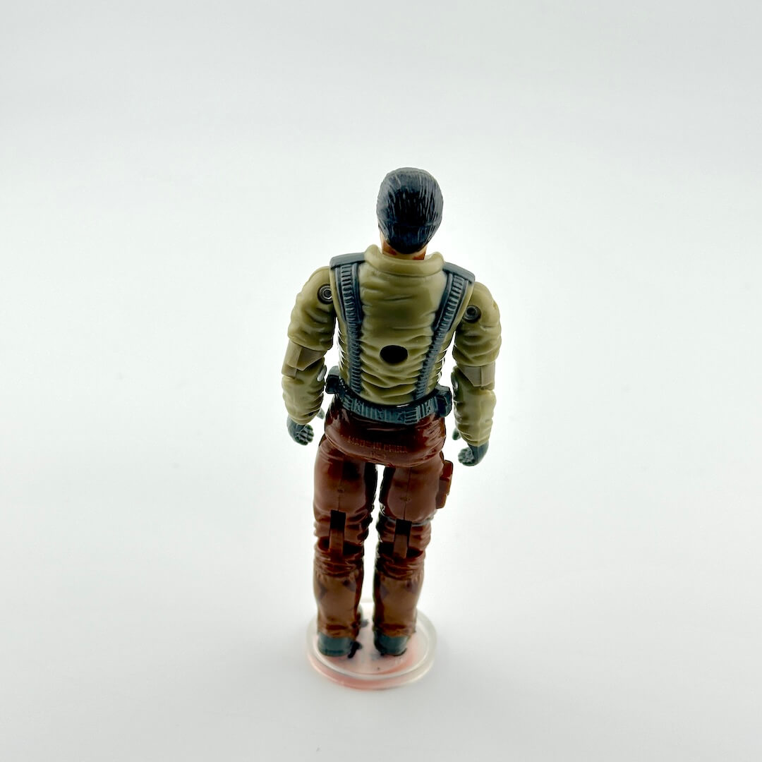 Action figure with a green jacket and brown pants on a white background
