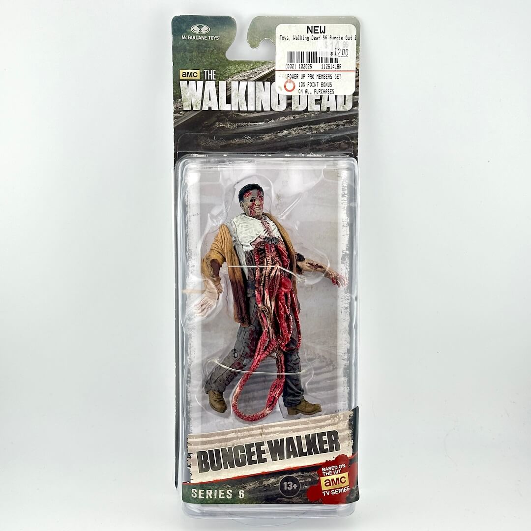 The Walking Dead Series 6 Bungee Walker action figure in its original packaging, featuring a detailed zombie character.