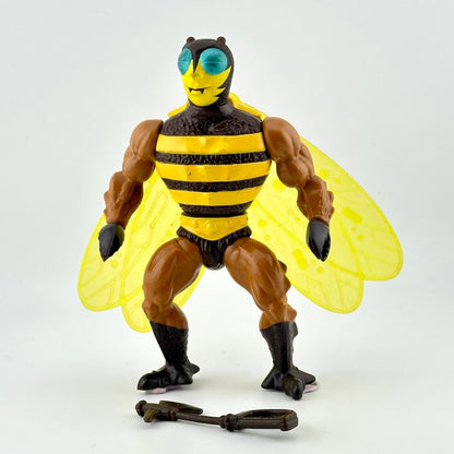 Toy figure of a bee-like character with yellow wings and striped body on a white background