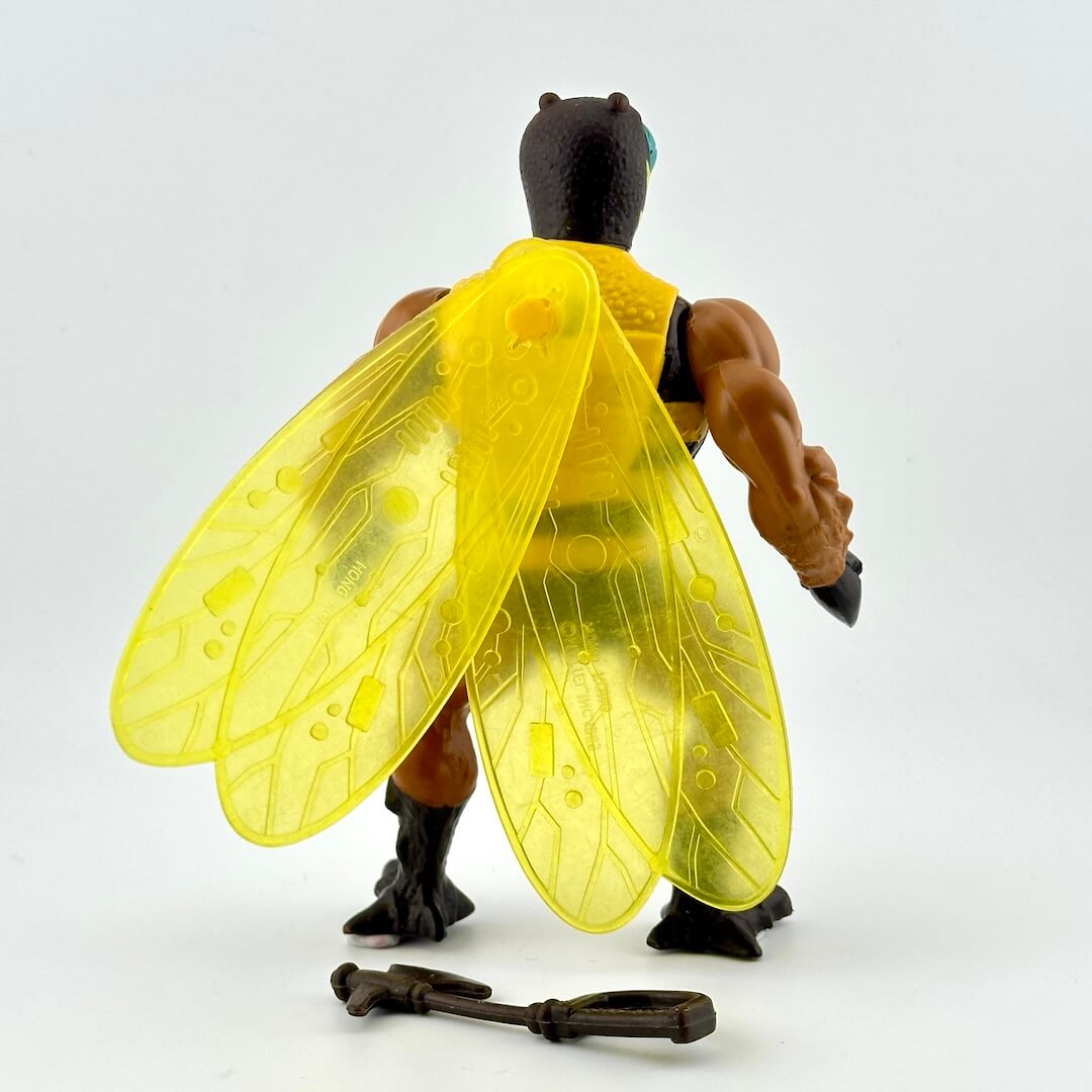 Toy figure with yellow wings and a key on a white background