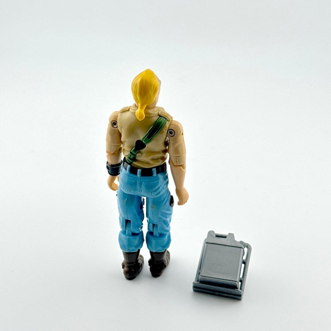 Action figure with blonde hair and blue pants on a white background