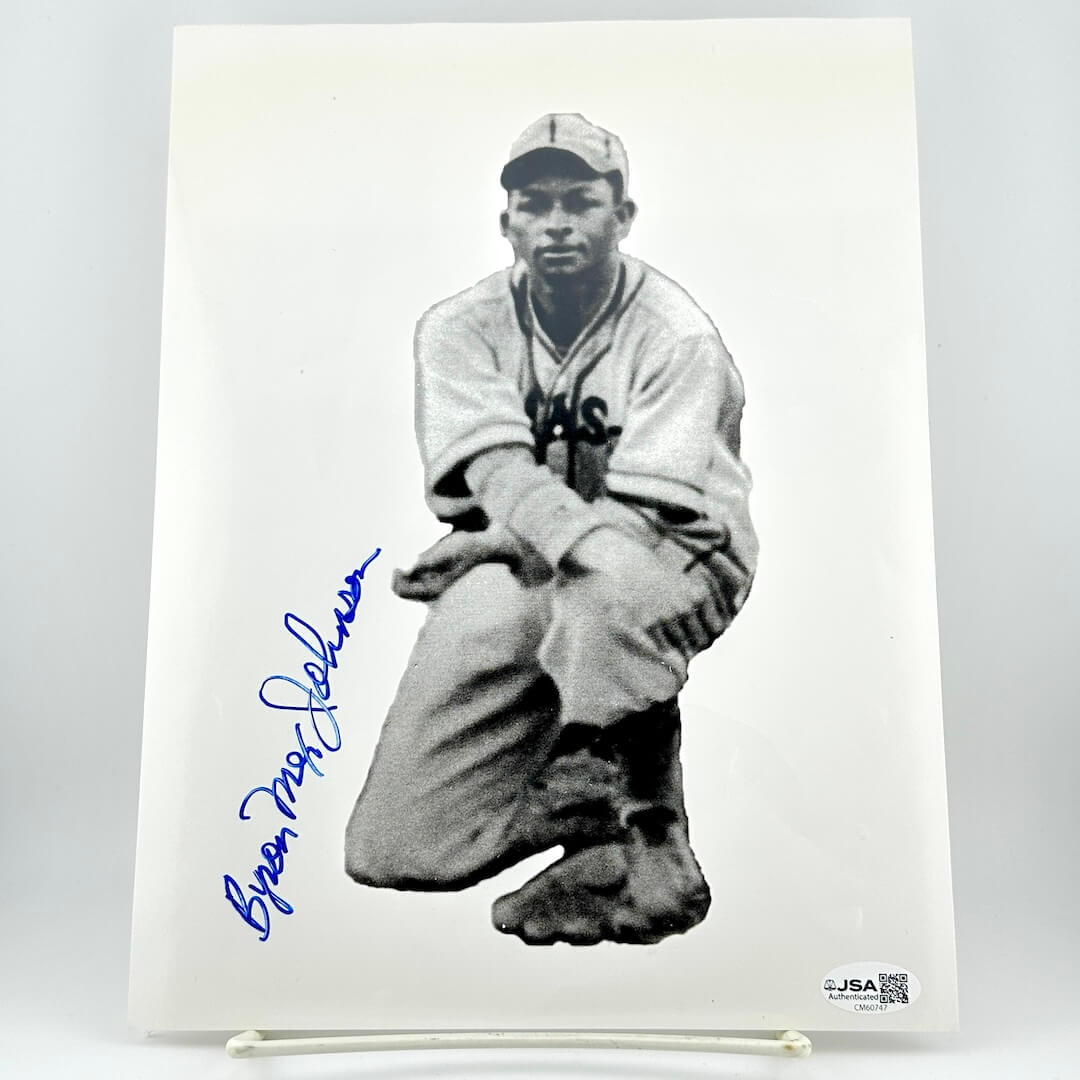 Black and white photo of a baseball player with an autograph on a white background