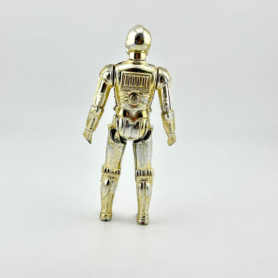 A metallic gold and silver robot action figure shown from the back, standing against a plain light gray background.