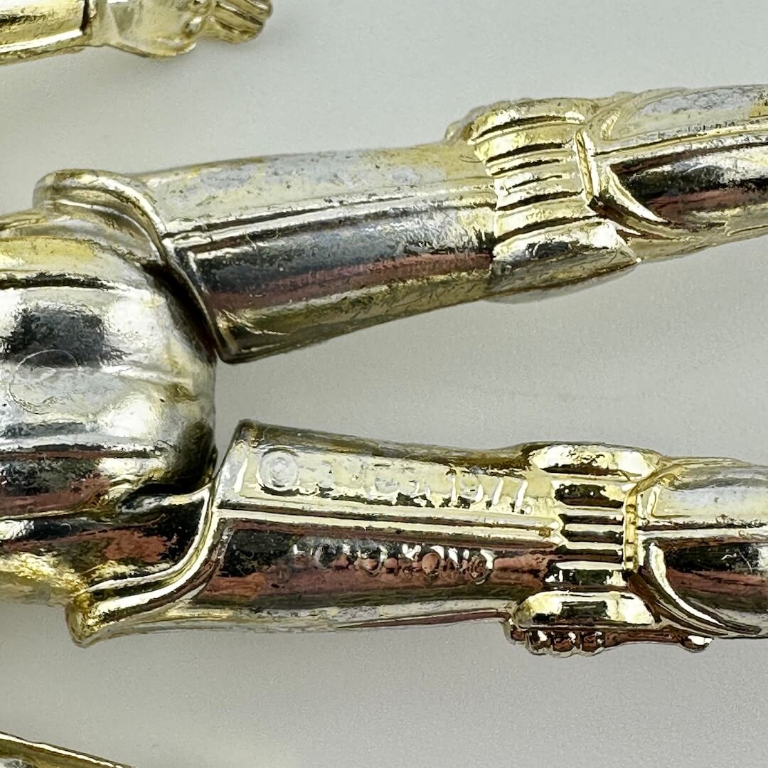 Close-up of COO and copyright information embossed on back of figure's leg. 