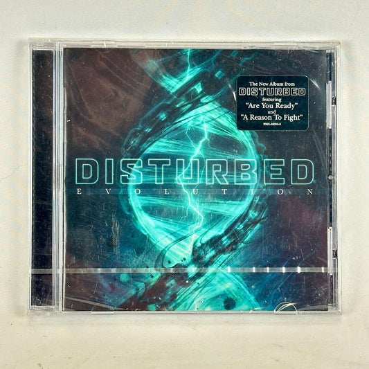 CD cover of Disturbed's 'Evolution' with abstract design and text.