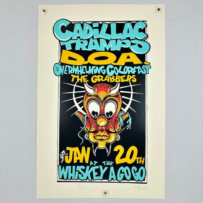 Vintage concert poster for Cadillac Tramps, DOA, and others with a colorful devil face illustration on a beige background.