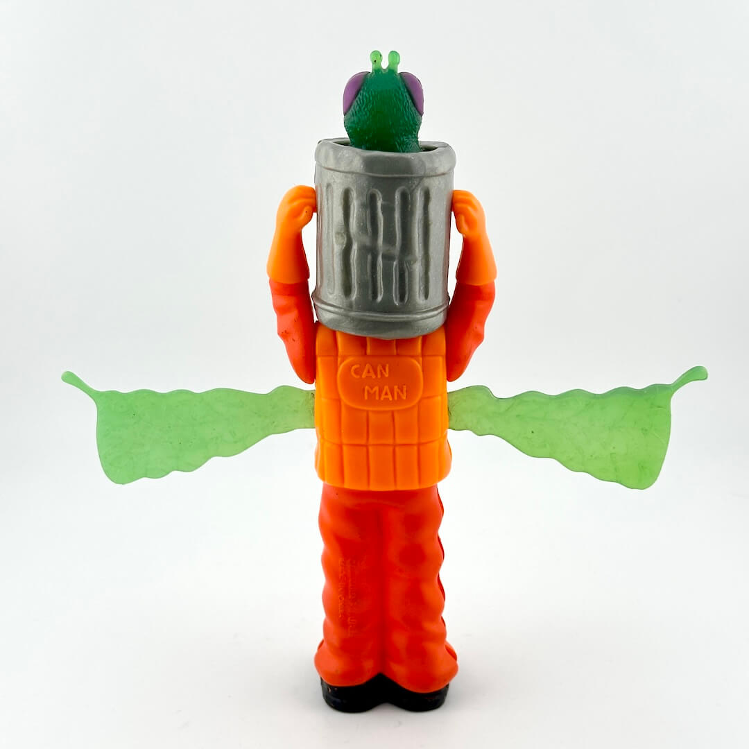 Toy figure resembling a character from a science fiction movie with an orange suit and green accents on a white background.