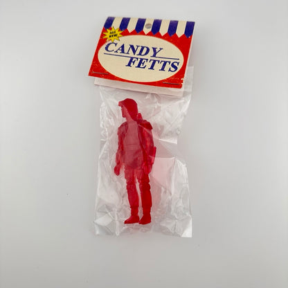 Red semi-transparent custom figure of Boba Fett classic action figure in packaging, clear plastic bag & card-stock tag.