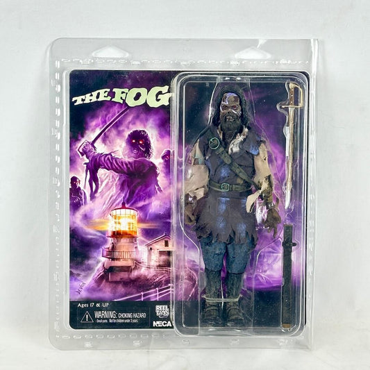 Action figure in packaging with 'The Fog' movie poster on a white background