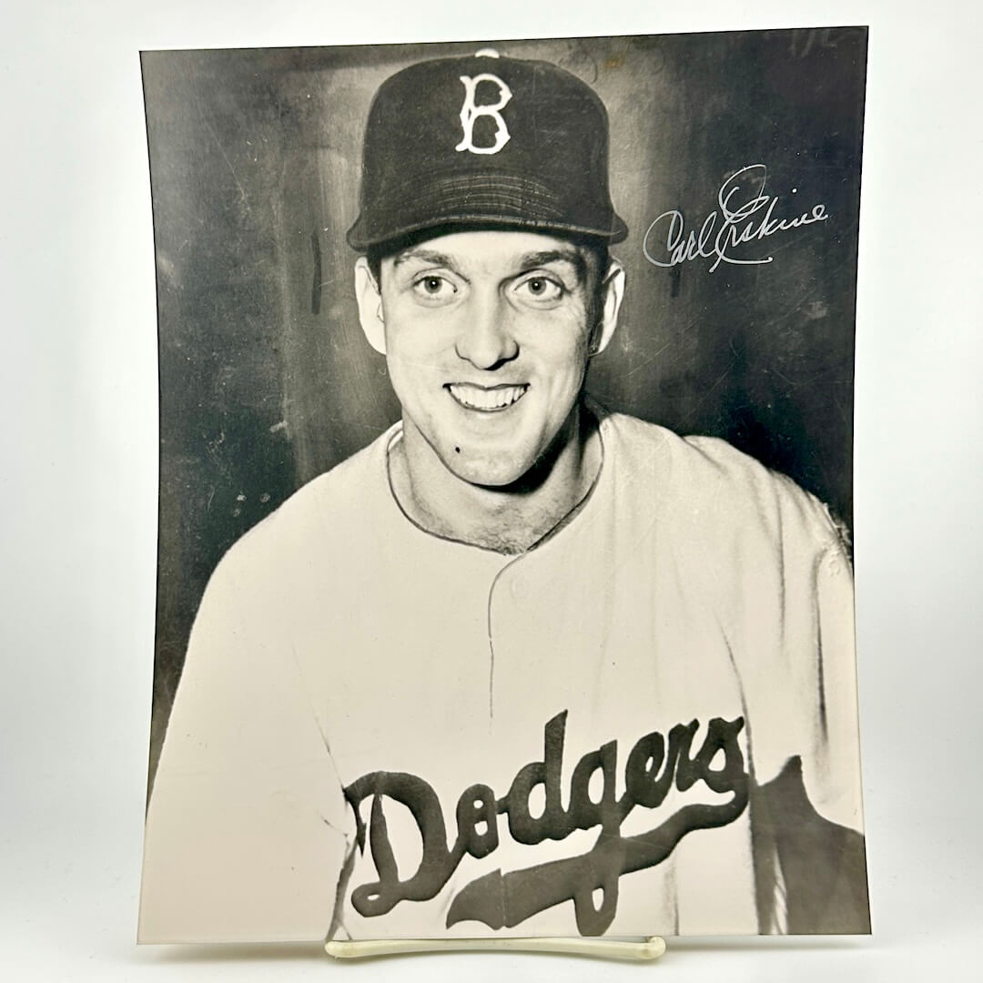 Black and white photo of a baseball player wearing a 'Dodgers' uniform with a cap.