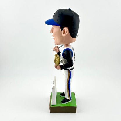 Bobblehead figure of a baseball player in a uniform with a bat and glove on a white background