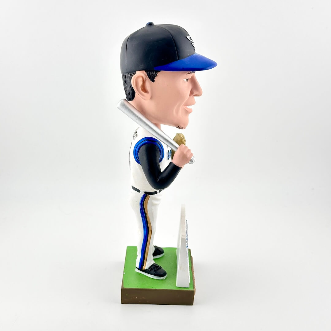 Bobblehead of a baseball player holding a bat on a white background