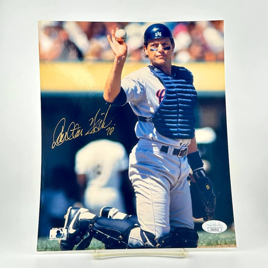 Baseball player in catcher's gear with a ball, on a white background