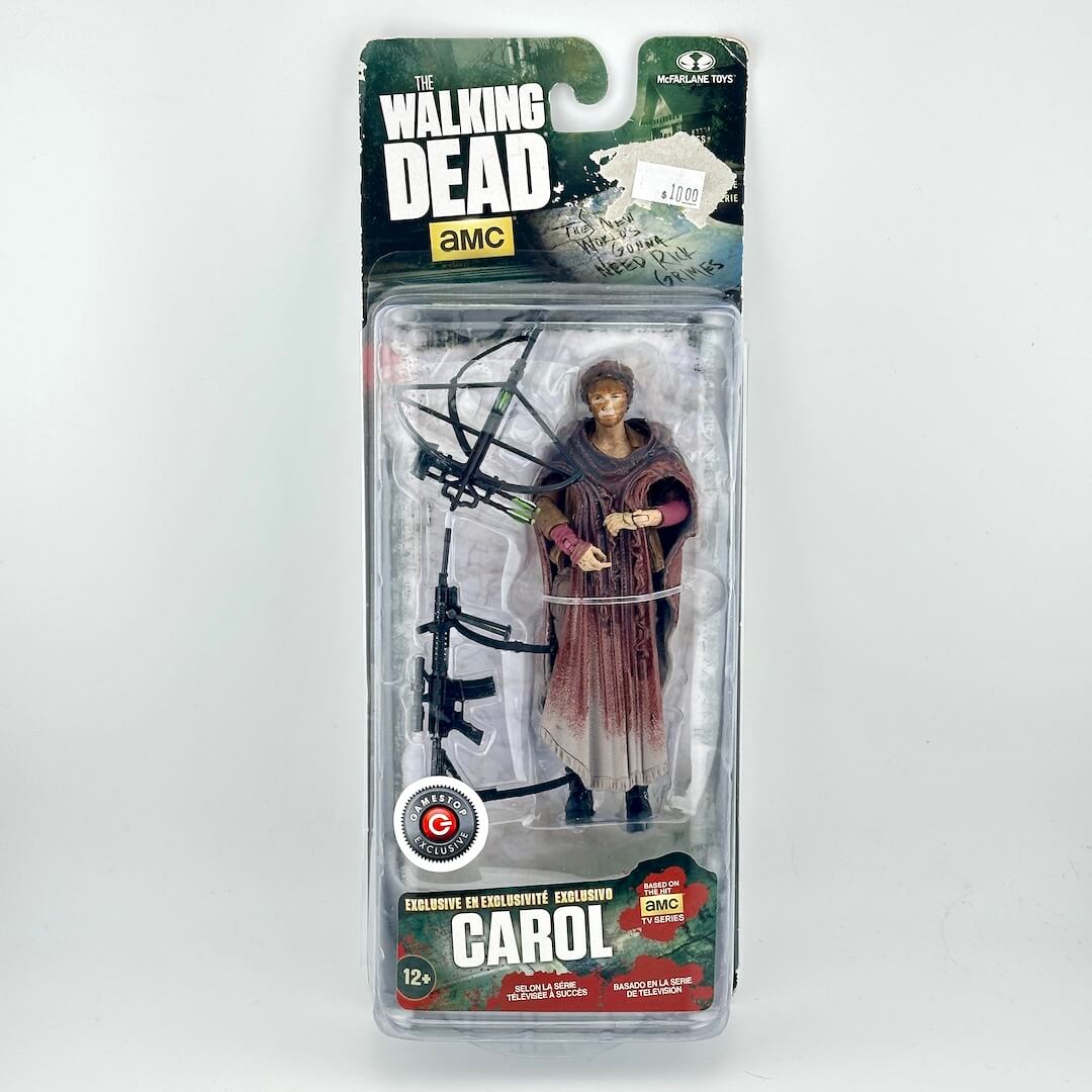 A packaged action figure of Carol from The Walking Dead, shown in its original blister pack with the card backing.
