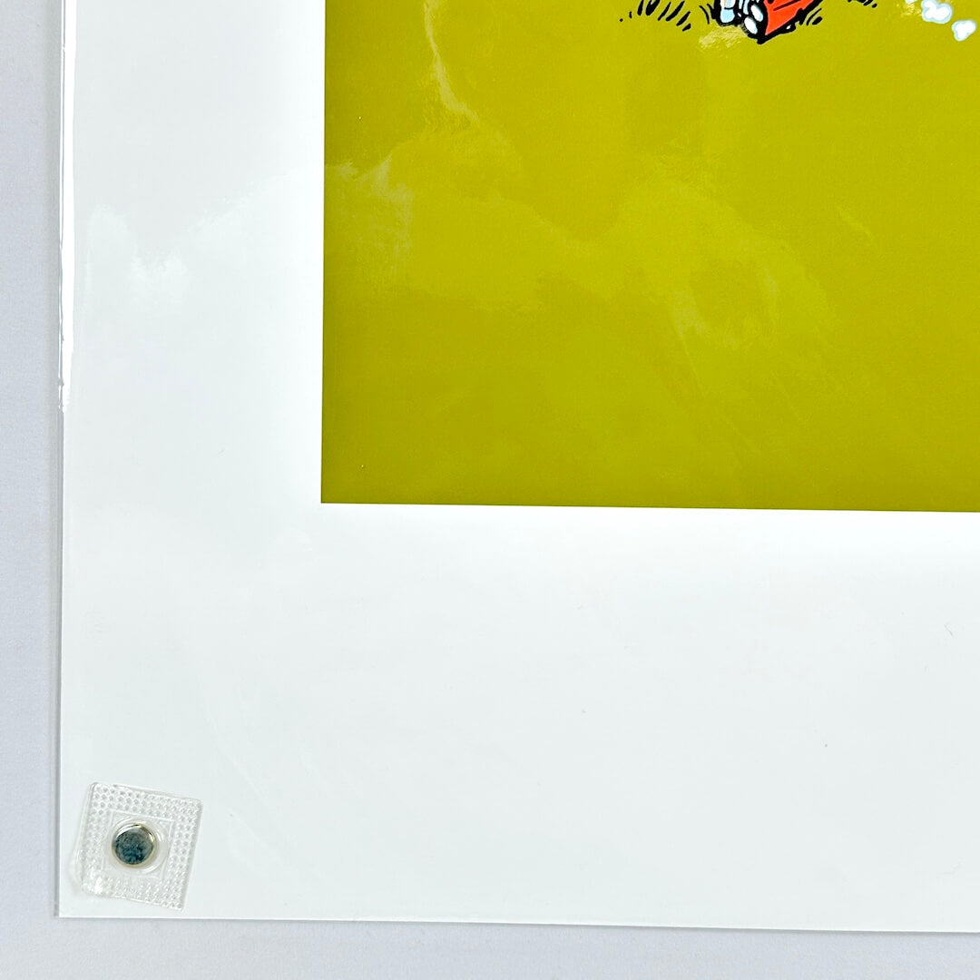 Lower left corner of print with sharp corner and good edges, wrapped in plastic on white background. 