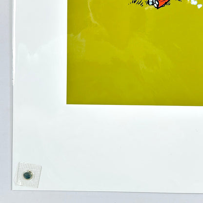 Lower left corner of print with sharp corner and good edges, wrapped in plastic on white background. 