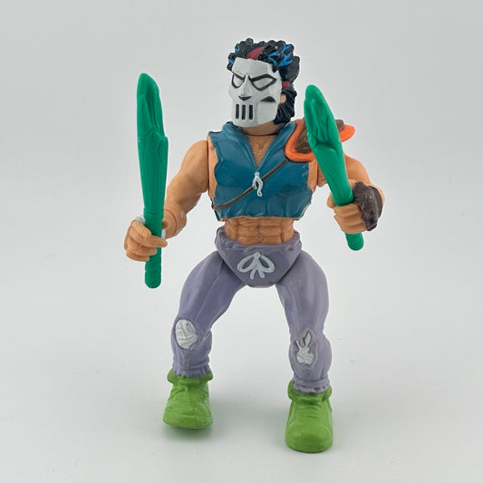 White male action figure wearing a hockey mask, shredded blue vest, and purple sweatpants, holding two teal bats. Front.
