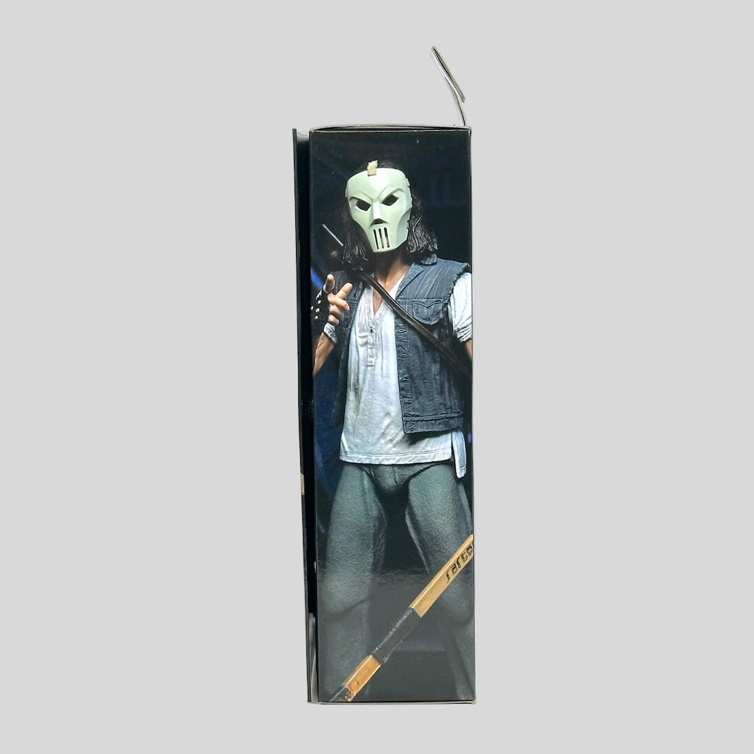 Action figure packaging with character holding a weapon on a white background