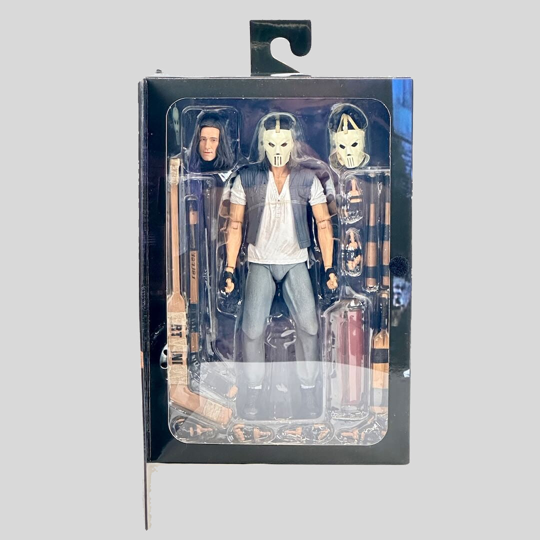 Action figure in packaging with a gray background