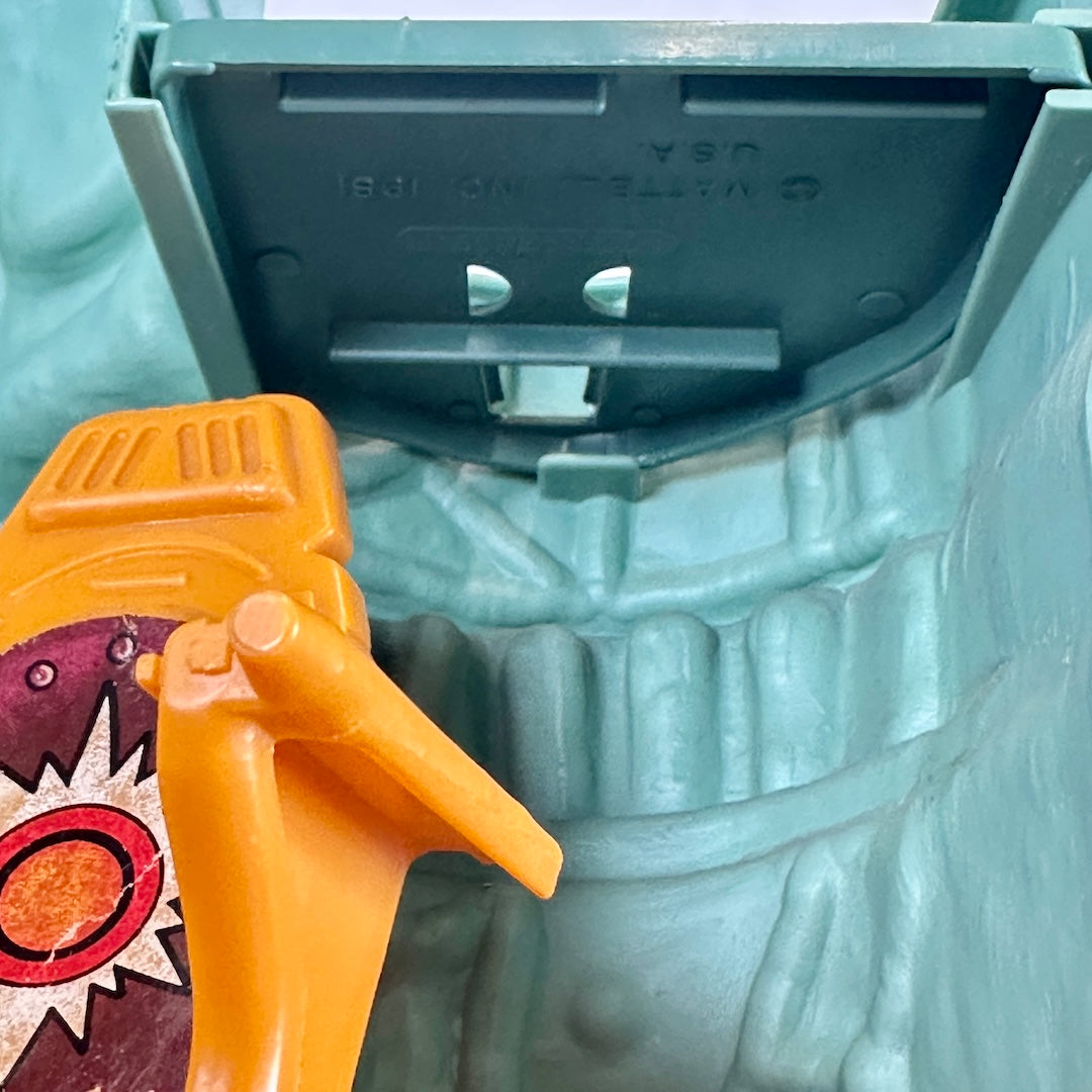 Close up of trap door with copyright information embossed into the plastic. 