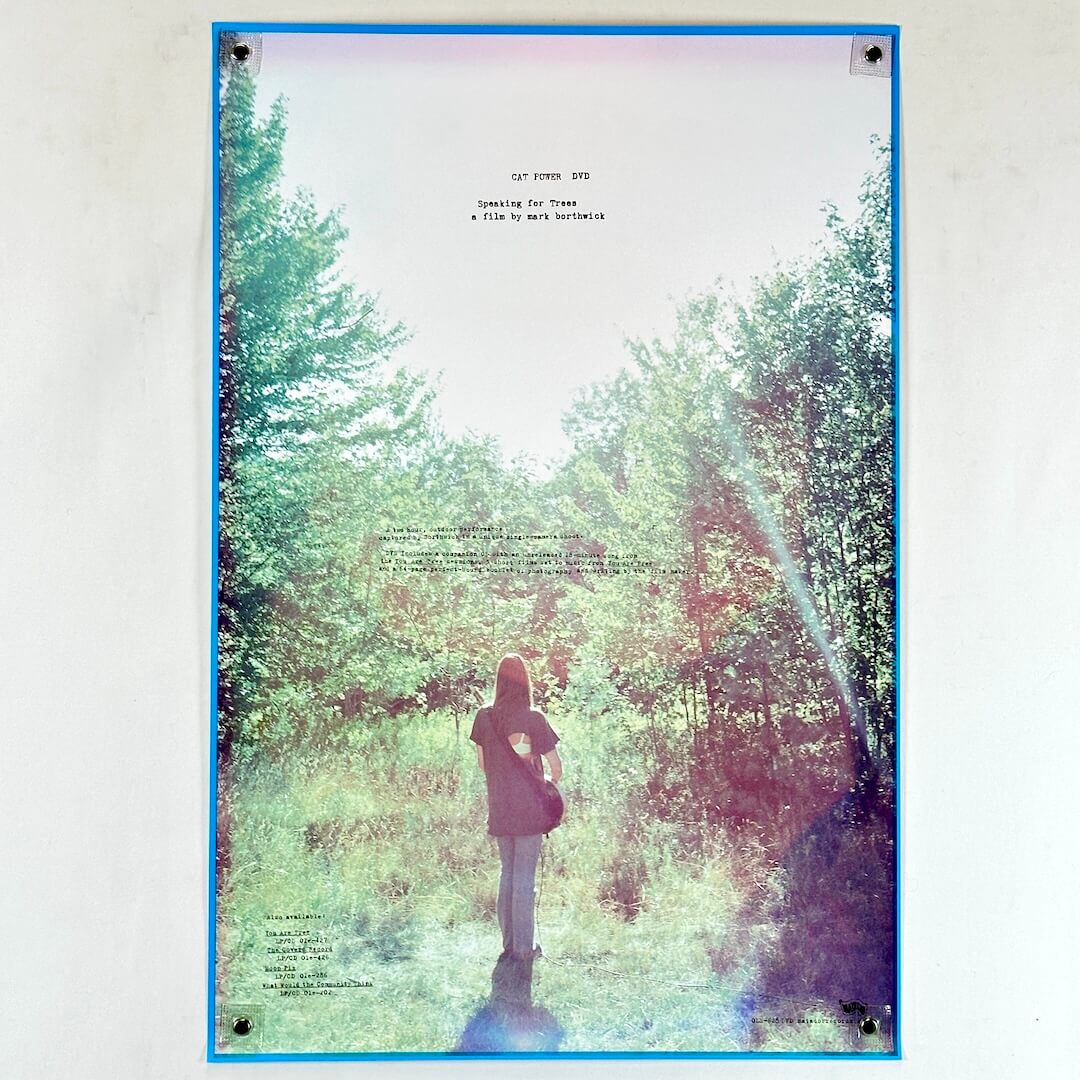 Poster of a person standing in a forest with a blue border