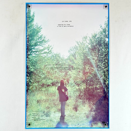 Poster of a person standing in a forest with a blue border