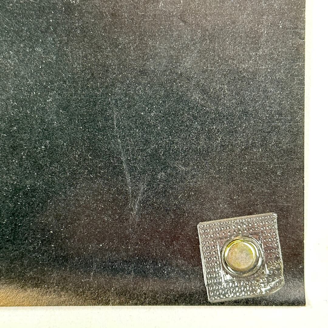 Bottom right corner of poster with light scratch. 