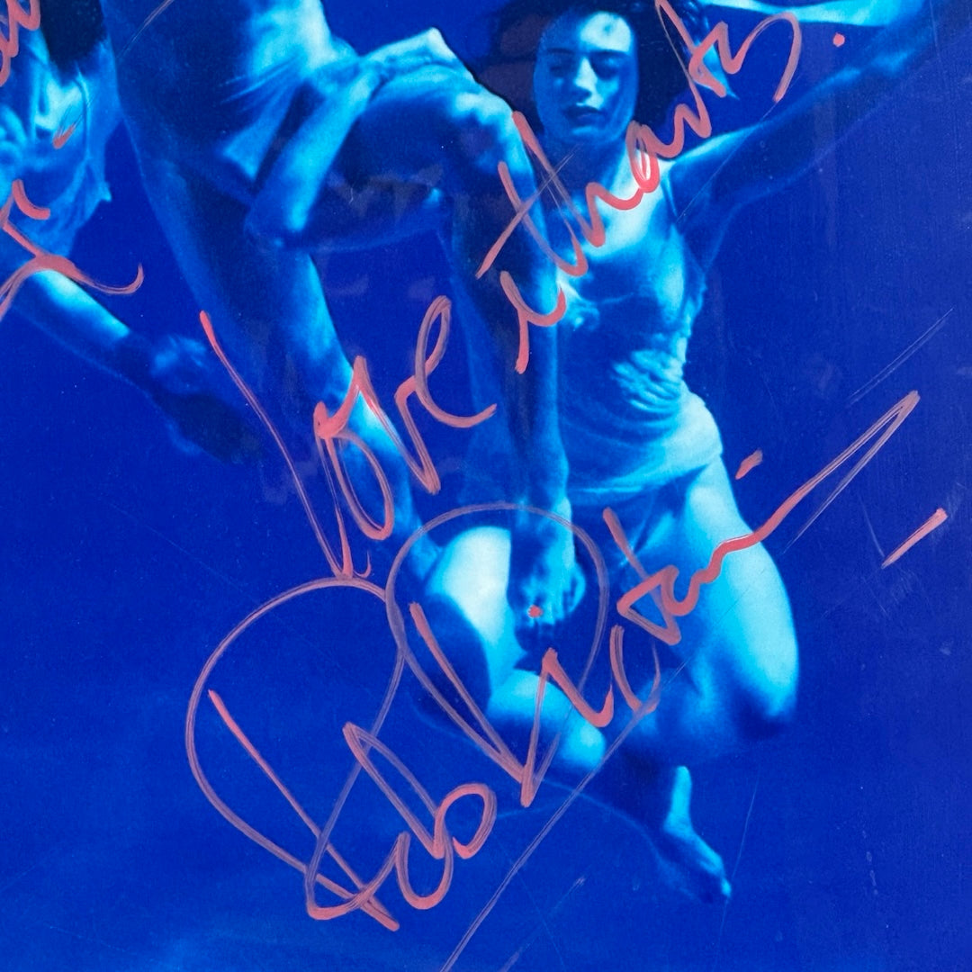 Close-up of pink cursive inscription & signature across center of poster, "Love thanks, Rob Dickinson."