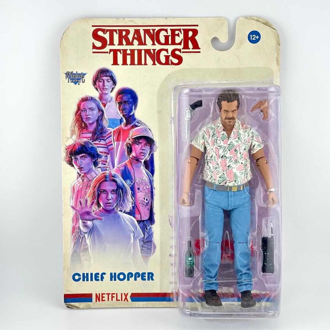 A Stranger Things Chief Hopper action figure in its original blister card packaging.