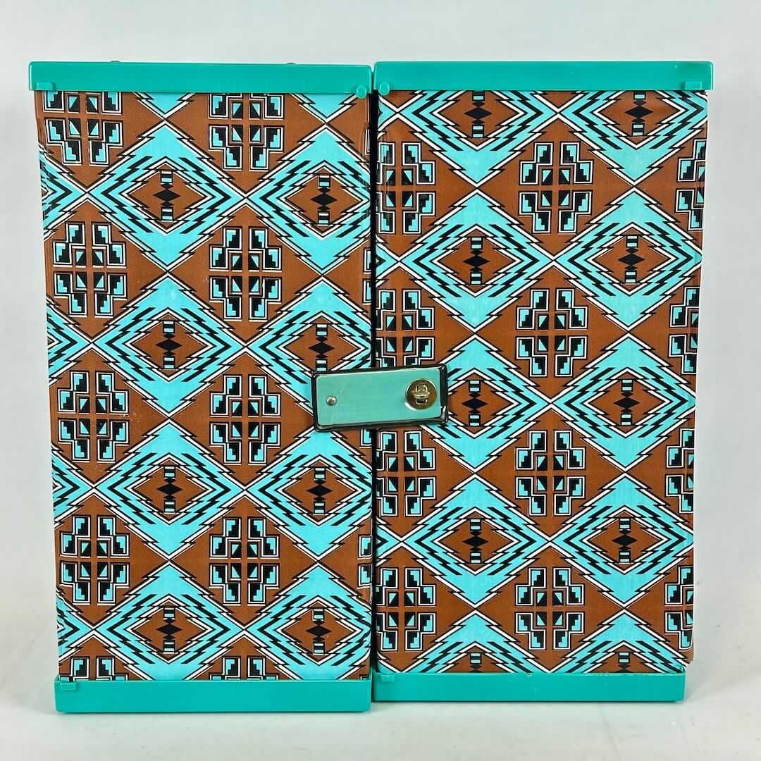 Two turquoise boxes with a geometric pattern on a light gray background