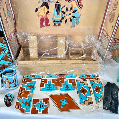 Close-up of contents to playset including geometric design stickers and plastic wrapped furniture. 